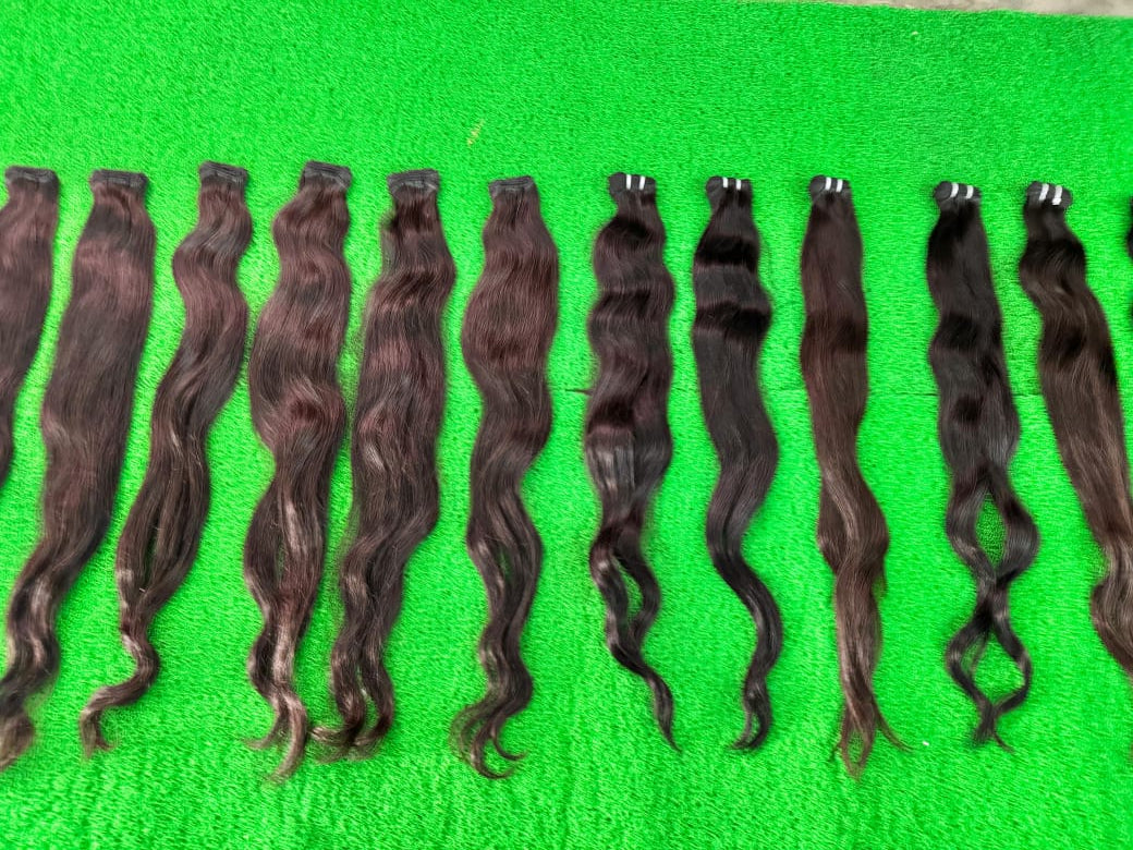 Set of brown hair extensions on a green background